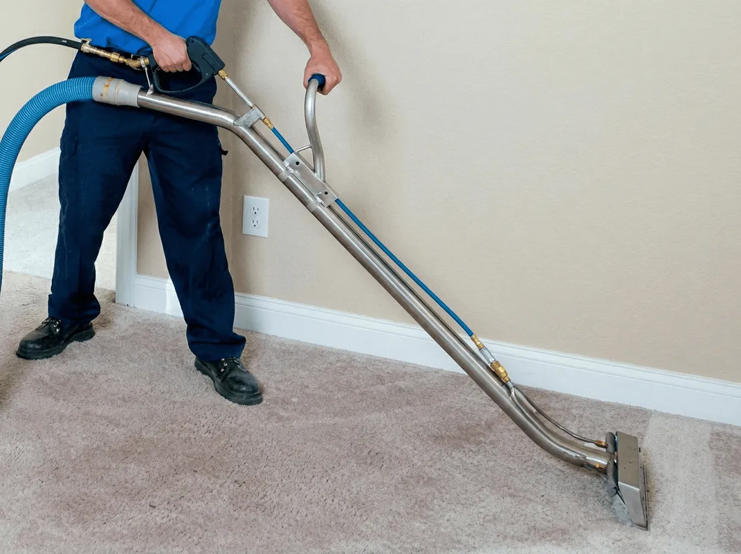 Professional operating a liquid removal machine on a carpeted floor in Bradenton, FL